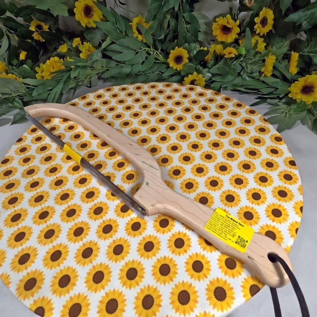 Saw with sunflower patterned handle and blade on a white background