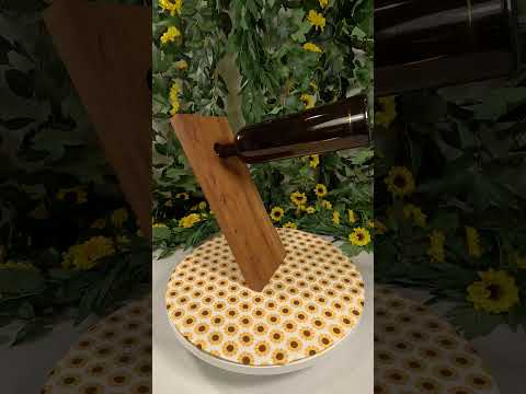 Link to a video with a cantilever wooden wine bottle holder and a wine bottle with a sunflower backdrop.